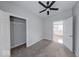 Bedroom featuring carpeted floors, a ceiling fan, and a walk-in closet with built-in shelving at 1641 Deloss St, Indianapolis, IN 46201