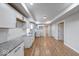 Modern kitchen featuring white cabinets, granite countertops, and stainless steel appliances at 1641 Deloss St, Indianapolis, IN 46201