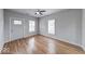 Bright living room with hardwood floors and a ceiling fan, showing entrance door at 1641 Deloss St, Indianapolis, IN 46201