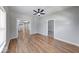 Bright living room with hardwood floors and a ceiling fan, open layout to other rooms at 1641 Deloss St, Indianapolis, IN 46201