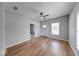 Bright living room with hardwood floors and a ceiling fan, showing entrance door at 1641 Deloss St, Indianapolis, IN 46201