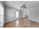 Bright living room with hardwood floors and a ceiling fan, open to modern kitchen at 1641 Deloss St, Indianapolis, IN 46201