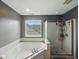 Bathroom featuring a large soaking tub and separate glass door shower at 1680 Woodfield Dr, Greenwood, IN 46143
