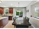 Bright dining area with dark wood table, modern chandelier, and sliding doors to the outdoor patio at 1680 Woodfield Dr, Greenwood, IN 46143