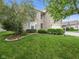 Charming two-story brick home with a well-maintained lawn and manicured landscaping at 1680 Woodfield Dr, Greenwood, IN 46143