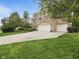 Spacious three-car garage with a long driveway and well-manicured lawn at 1680 Woodfield Dr, Greenwood, IN 46143