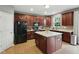 Well-equipped kitchen with an island, dark wood cabinetry, and stainless steel appliances at 1680 Woodfield Dr, Greenwood, IN 46143
