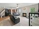 Open living area with a fireplace, TV, and view into the adjacent kitchen at 1680 Woodfield Dr, Greenwood, IN 46143