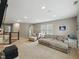 Bright living room featuring a large sectional sofa, plush chair, and a carpeted floor at 1680 Woodfield Dr, Greenwood, IN 46143