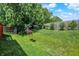 Spacious backyard featuring a lush lawn and a hanging flower basket for outdoor enjoyment at 17401 Austrian Pine Way, Westfield, IN 46074