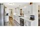 A sunlit kitchen featuring white cabinets, updated appliances and new counter tops at 17401 Austrian Pine Way, Westfield, IN 46074