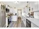 Bright kitchen with white cabinets, stainless steel appliances, and updated countertops at 17401 Austrian Pine Way, Westfield, IN 46074