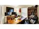 Well-lit home office with a wooden desk, shelving, and comfortable seating at 17401 Austrian Pine Way, Westfield, IN 46074
