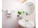 Cozy powder room with pedestal sink, decorative mirror and fixtures at 1856 Misty Lake Dr, Indianapolis, IN 46260