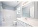 Bathroom with a large mirror, white vanity, shower, and a bright window at 1856 Misty Lake Dr, Indianapolis, IN 46260