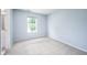 Bedroom featuring light blue walls, neutral carpet and bright window view at 1856 Misty Lake Dr, Indianapolis, IN 46260