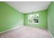 Bright, spacious bedroom with plush carpet, large window, and neutral walls at 1856 Misty Lake Dr, Indianapolis, IN 46260