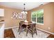 Charming dining area with modern table and chairs, hardwood floors, stylish decor and plenty of natural light at 1856 Misty Lake Dr, Indianapolis, IN 46260