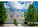 Charming townhouse with a two-car garage, lovely landscaping and inviting curb appeal on a beautiful, sunny day at 1856 Misty Lake Dr, Indianapolis, IN 46260