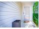 Inviting covered porch with a screen door, neutral siding, exterior light, and an outdoor wicker container at 1856 Misty Lake Dr, Indianapolis, IN 46260