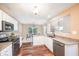 Bright kitchen features granite countertops, white cabinets, and stainless steel appliances at 1856 Misty Lake Dr, Indianapolis, IN 46260
