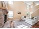 Bright living room with a brick fireplace, hardwood floors, vaulted ceiling, a ceiling fan and a comfortable sofa at 1856 Misty Lake Dr, Indianapolis, IN 46260