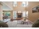 Cozy living room with a brick fireplace, hardwood floors, a comfortable sofa and a view of the dining area at 1856 Misty Lake Dr, Indianapolis, IN 46260