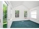 Bright sun room with large windows and glass door overlooking lush greenery at 1856 Misty Lake Dr, Indianapolis, IN 46260
