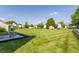Expansive backyard with a patio, well-manicured lawn, and mature trees at 19469 Amber Way, Noblesville, IN 46060