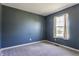 Bedroom with blue walls and a window with natural light, perfect for relaxation at 19469 Amber Way, Noblesville, IN 46060