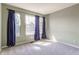 Bright room features three sunny windows framed by dark blue curtains and neutral paint at 19469 Amber Way, Noblesville, IN 46060