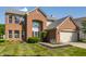 Charming brick two-story home with well-manicured lawn and attached two-car garage at 19469 Amber Way, Noblesville, IN 46060