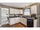 Clean kitchen with white cabinets, stainless steel appliances, and wood floors at 19469 Amber Way, Noblesville, IN 46060