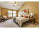 Bright main bedroom featuring a ceiling fan, vaulted ceilings, warm paint, and complementary furniture at 19469 Amber Way, Noblesville, IN 46060