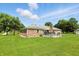Brick home featuring an outdoor deck, chimney, and expansive backyard at 1981 N Valley Ln, Greenfield, IN 46140