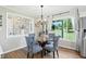 Dining area with a glass table and patterned chairs connects to the kitchen and decorative passthrough at 1981 N Valley Ln, Greenfield, IN 46140