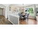 Cozy dining area with glass table and patterned chairs connects to a decorative kitchen passthrough at 1981 N Valley Ln, Greenfield, IN 46140