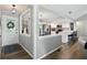 Light-filled entryway with front door, adjacent dining area, and access to the main living spaces at 1981 N Valley Ln, Greenfield, IN 46140