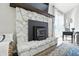 Detailed view of the stone fireplace with wood accents and hardwood floors at 1981 N Valley Ln, Greenfield, IN 46140