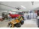 Spacious garage interior featuring ample storage, a boat, and lawn equipment, providing convenience and organization at 1981 N Valley Ln, Greenfield, IN 46140