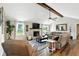 Spacious living room featuring stone fireplace, wood beam, and hardwood floors at 1981 N Valley Ln, Greenfield, IN 46140