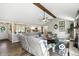 Open living room with wood beam, stone fireplace, hardwood floors, and natural light at 1981 N Valley Ln, Greenfield, IN 46140
