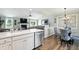 Open concept living spaces features fireplace, ceiling fan, and seamlessly flows into the eat-in kitchen at 1981 N Valley Ln, Greenfield, IN 46140