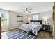 Serene main bedroom featuring a ceiling fan, two windows, and wood-look flooring at 1981 N Valley Ln, Greenfield, IN 46140
