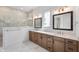 Elegant bathroom with double vanity, wood cabinets, marble floors, and glass-enclosed shower at 19832 Chatsworth Blvd, Westfield, IN 46074