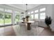 Bright dining room with modern decor, hardwood floors, many windows, and adjacent outdoor access at 19832 Chatsworth Blvd, Westfield, IN 46074