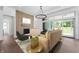 Bright living room with fireplace, hardwood floors, modern lighting, and sliding glass doors at 19832 Chatsworth Blvd, Westfield, IN 46074