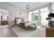 Serene bedroom with plush bedding, neutral tones, hardwood floors, and large windows at 19832 Chatsworth Blvd, Westfield, IN 46074