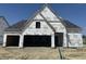 New construction home featuring Tyvek home wrap, an attached garage, and a newly installed roof in a suburban neighborhood at 19990 Stone Side Dr, Westfield, IN 46074