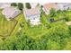 Aerial view of the backyard with a patio, basketball hoop, fire pit, and lush green lawn at 2029 Seven Peaks Dr, Cicero, IN 46034